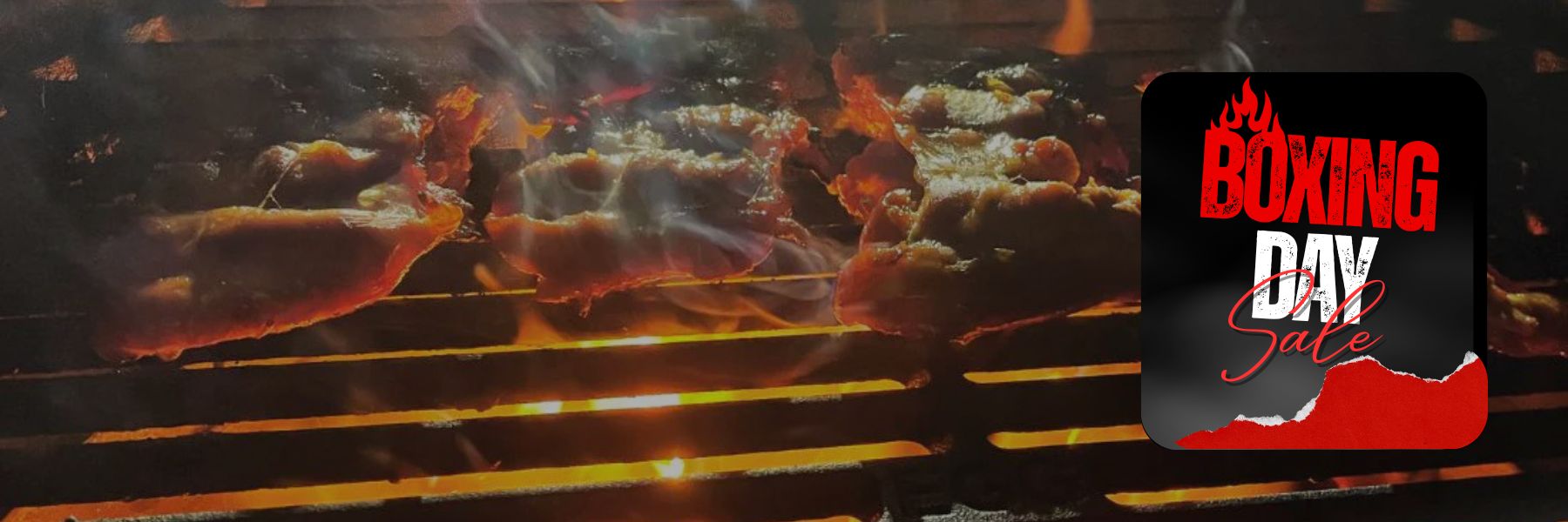 Grilled meats on a barbecue with a Boxing Day sale logo overlay.