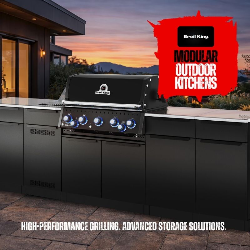 Broil King modular outdoor kitchen grill installed in a modern black outdoor kitchen setup at dusk, with a red 'Modular Outdoor Kitchens' graphic overlay and marketing text at the bottom.