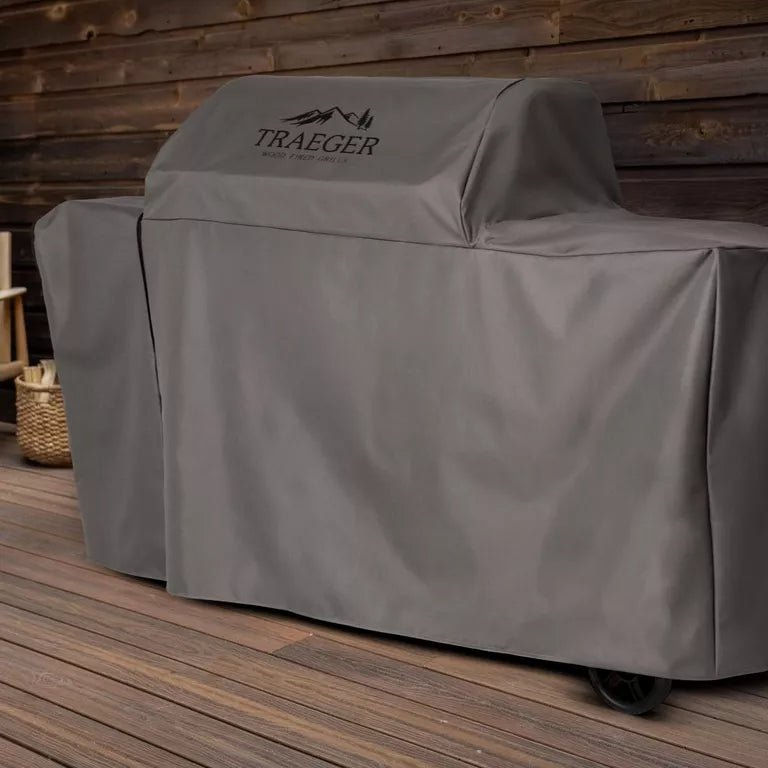 Traeger grill cover on a wooden deck with a wooden wall background