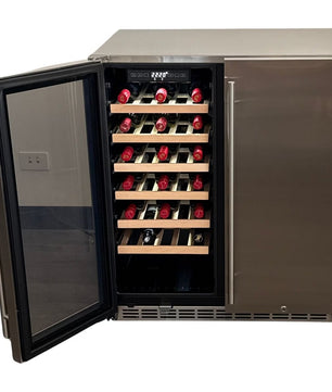 A stainless steel wine refrigerator with an open glass door, showing multiple shelves with wine bottles on wooden racks against a white background.