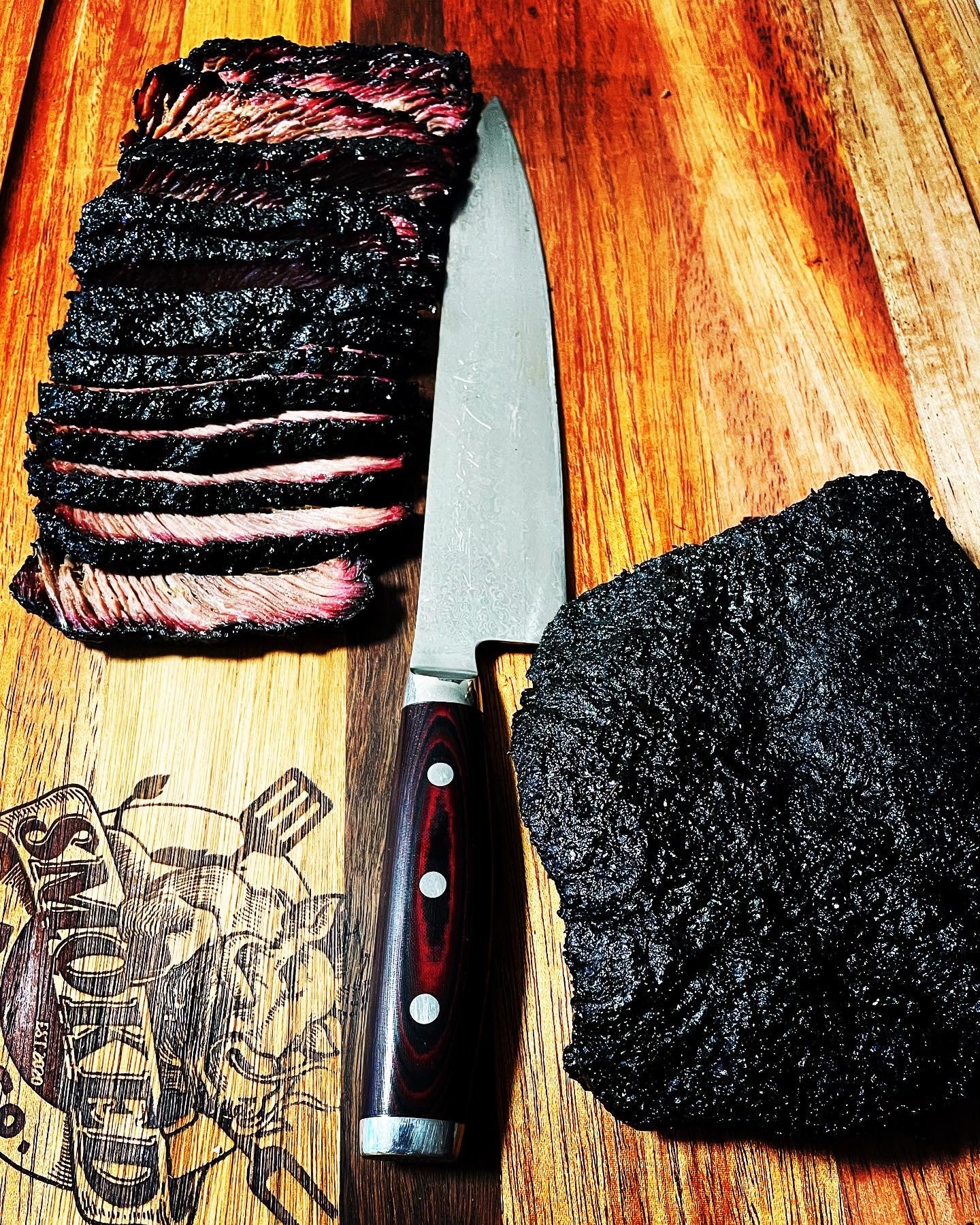 Beef brsiket sliced and displayed on Smoked BBQ Co branding serving board