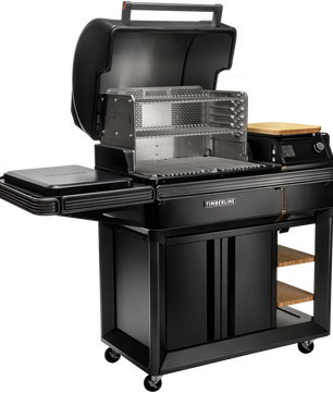Black barbecue grill with multiple cooking surfaces on a white background