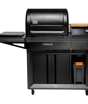 Black outdoor grill with wooden cutting board on a white background