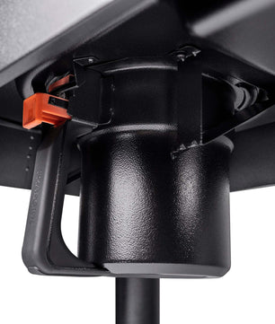 Close-up of a black mechanical component with an orange connector on a white background