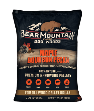 A 20 lb bag of Bear Mountain Premium BBQ Woods Maple Bourbon Pecan hardwood pellets, featuring a dark navy blue bag with a brown bear logo and product details.