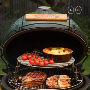 Big Green Egg grill with food and vegetables on a patio