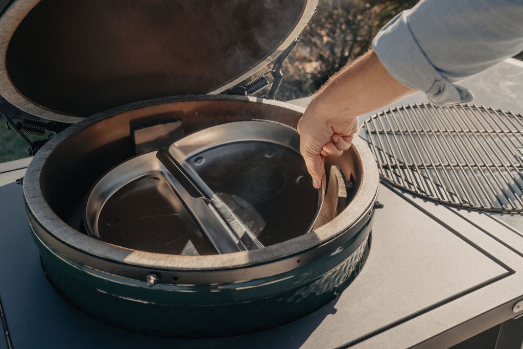 Person interacting with a green barbecue grill on a boat