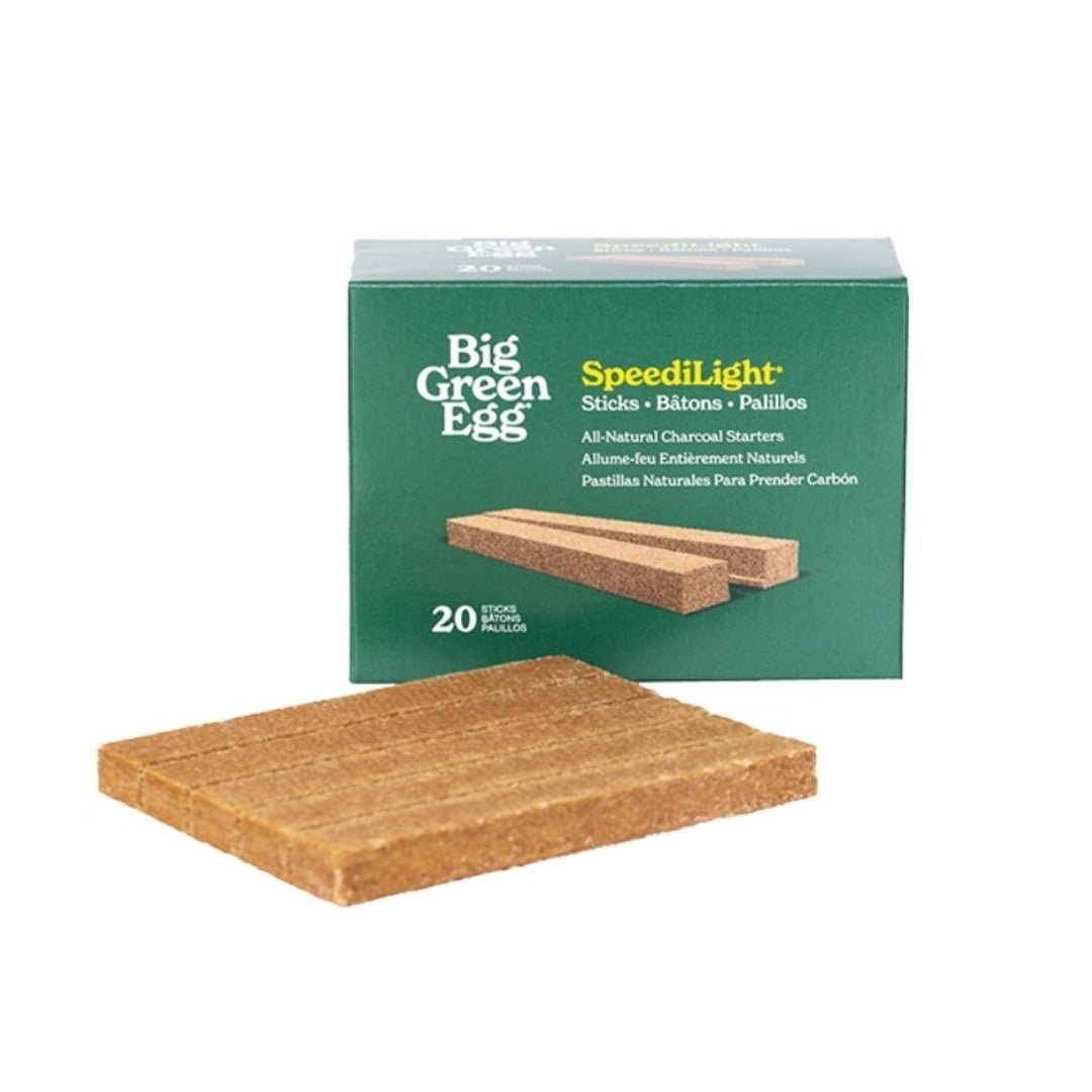 A package of Big Green Egg SpeedLight natural charcoal starter sticks, with one rectangular wood stick displayed in front of the green box on a white background.