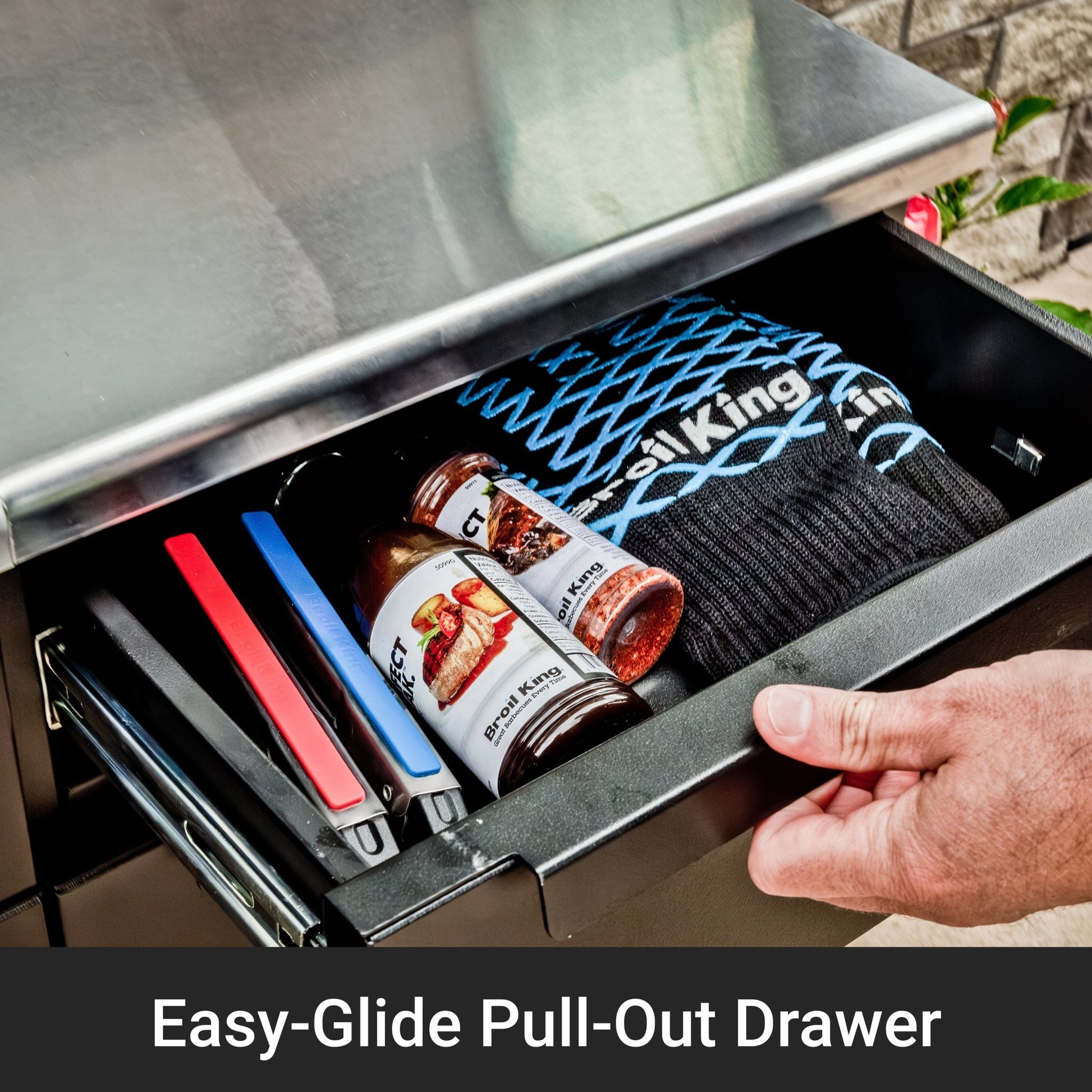 Hand opening a metal drawer with Fossil King products inside, labeled 'Easy-Glide Pull-Out Drawer'.