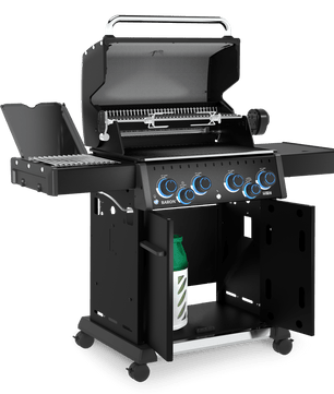 A black gas grill with an open lid, side tables on both sides, four control knobs with blue accents, and a lower storage cabinet door open to reveal a green bottle inside, shown on a plain white background.