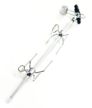 A metal spider-themed tool or accessory with a long silver rod, two spider-shaped wire arms, and a black knob, photographed on a plain white background.