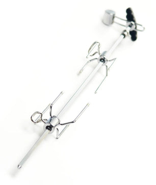A metal spider-themed tool or accessory with a long silver rod, two spider-shaped wire arms, and a black knob, photographed on a plain white background.
