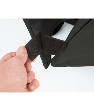 Hand adjusting a black strap on a car seat cover against a white background