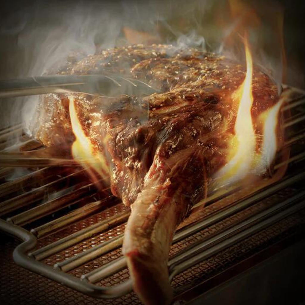 Close up of steak cooking on a grill