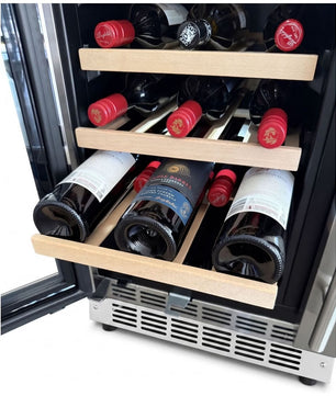 A wine cooler with a black interior and light wood shelves, stocked with wine bottles. The cooler door is open, showing the interior layout and a stainless steel vented base against a white background.