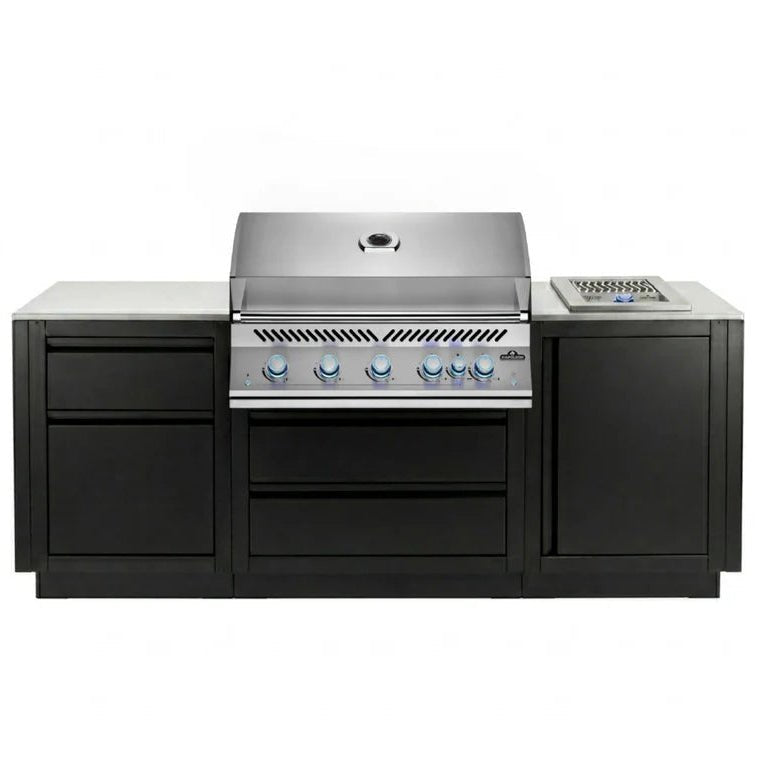 A professional outdoor kitchen island set featuring a stainless steel gas grill with six blue-tipped knobs, a matching stainless steel side burner, and black cabinets with a light gray stone countertop, shown against a plain white background.