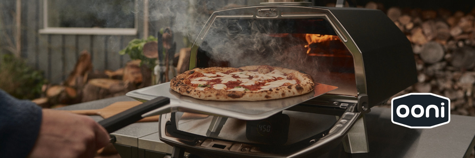 Backyard pizza being coooked on Ooni 'Karu 2 Pro' Multi-Fuel Pizza Oven