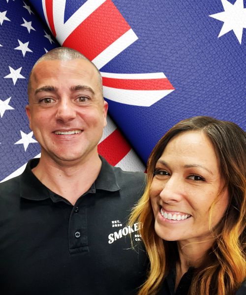 Owners Trent and Cassie in front of the USA and Australian flags