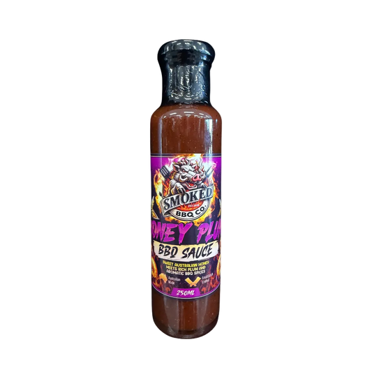A 250ml bottle of Smoked BBQ Co Honey Plum BBQ Sauce, featuring a black cap and a colorful label with a dragon graphic, set against a plain white background.