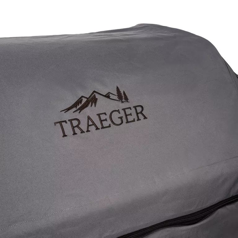 Gray Traeger grill cover with logo on a white background