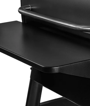 Close-up of a black chair with a tray on a white background