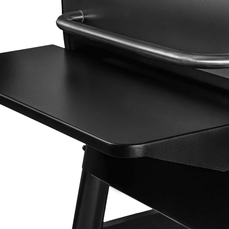 Close-up of a black chair with a tray on a white background
