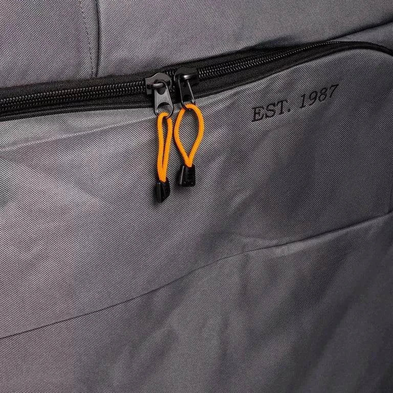 Close-up of a gray bag with a zipper and 'EST. 1987' branding.