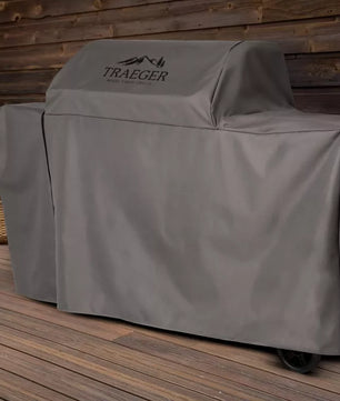 Traeger grill cover on a wooden deck with a wooden wall background