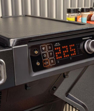 Portable grill with digital temperature display on a stand