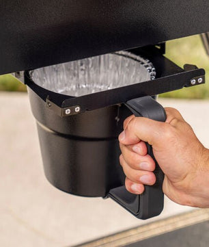 Hand using a cup holder on a vehicle's dashboard