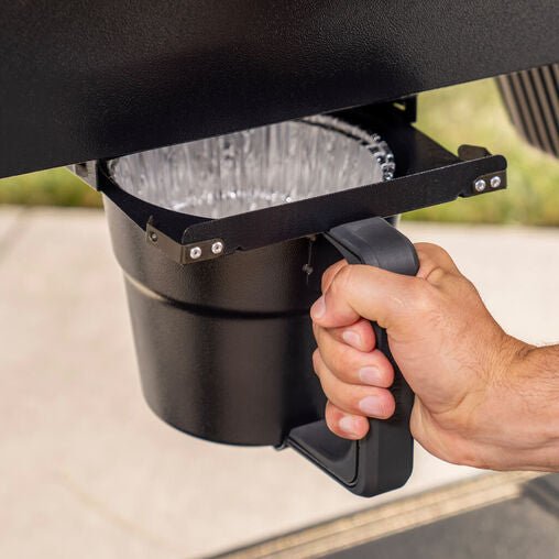 Hand using a cup holder on a vehicle's dashboard