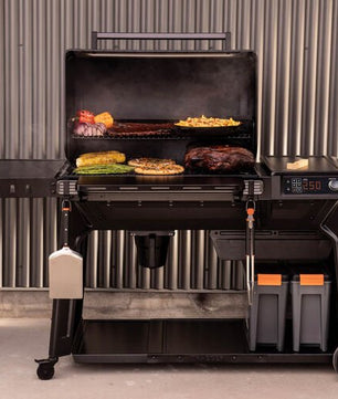 Multifunctional grill with cooking area and side burners on a gray background